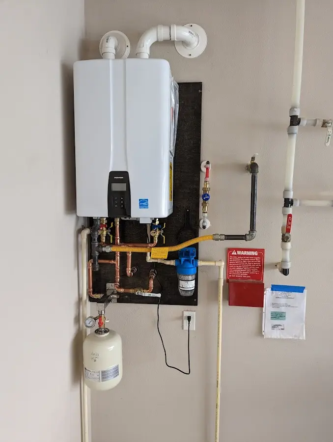 Professional plumber installing copper piping in a Omaha home